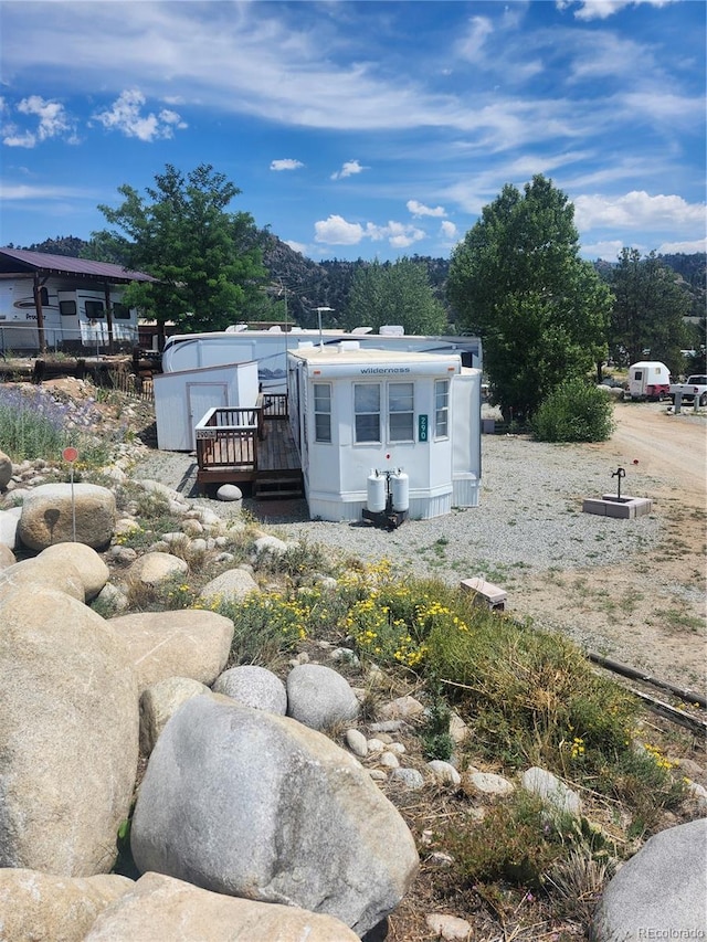 exterior space featuring a deck with mountain view