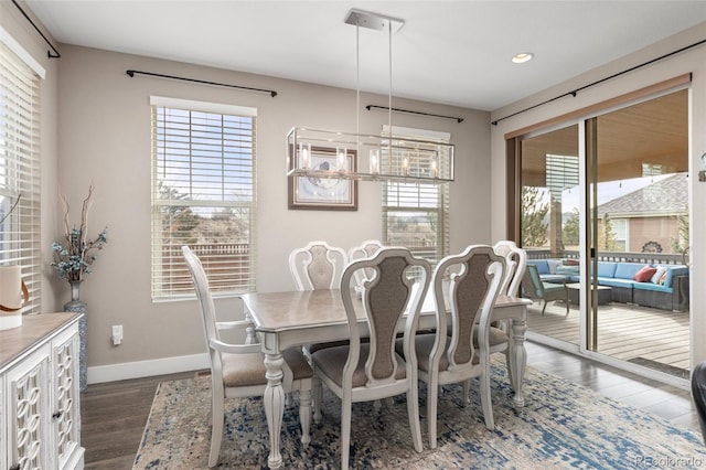 dining room featuring dark hardwood / wood-style flooring and a notable chandelier