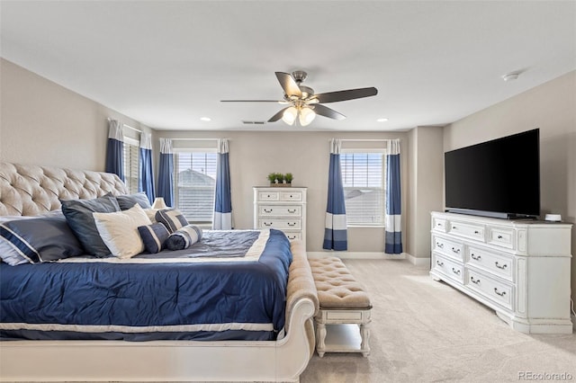 carpeted bedroom with multiple windows and ceiling fan