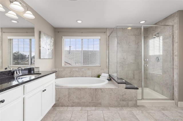 bathroom featuring vanity, tile patterned flooring, plenty of natural light, and independent shower and bath