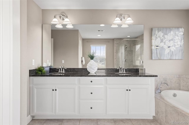 bathroom with tile patterned floors, vanity, and independent shower and bath