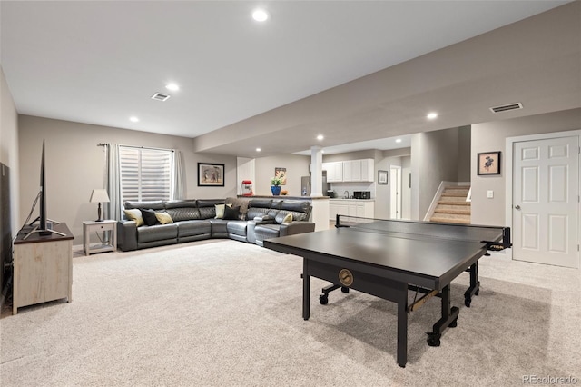 recreation room featuring light colored carpet