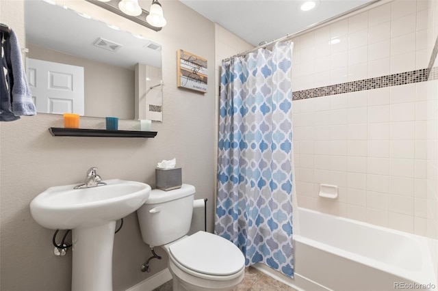 full bathroom with tile patterned flooring, sink, shower / bath combo with shower curtain, and toilet