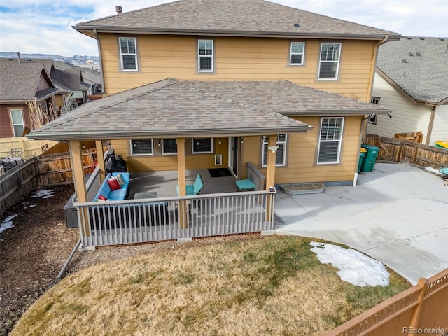 rear view of house with a yard and a patio