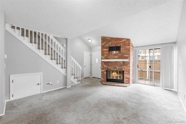 14343 E Dickinson Dr Unit E, Aurora, CO 80014 - unfurnished living room featuring carpet floors, a textured ceiling, a fireplace, and stairway