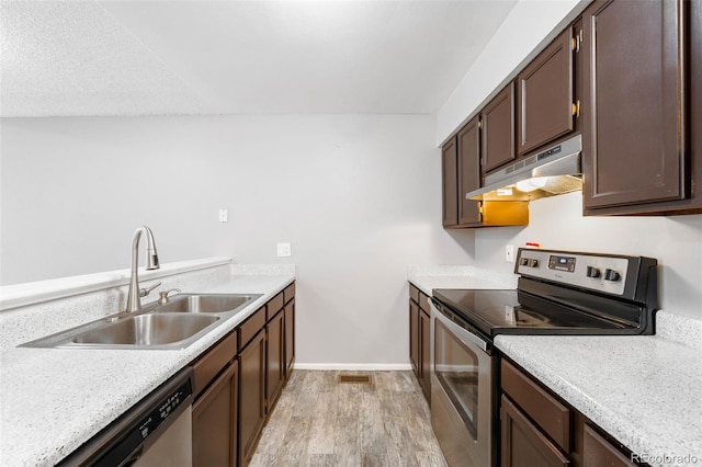 14343 E Dickinson Dr Unit E, Aurora, CO 80014 - kitchen with light wood-style floors, light countertops, under cabinet range hood, a sink, and stainless steel appliances