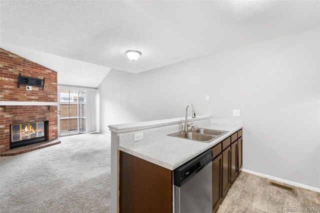 14343 E Dickinson Dr Unit E, Aurora, CO 80014 - kitchen with visible vents, dark brown cabinetry, light countertops, a sink, and dishwasher