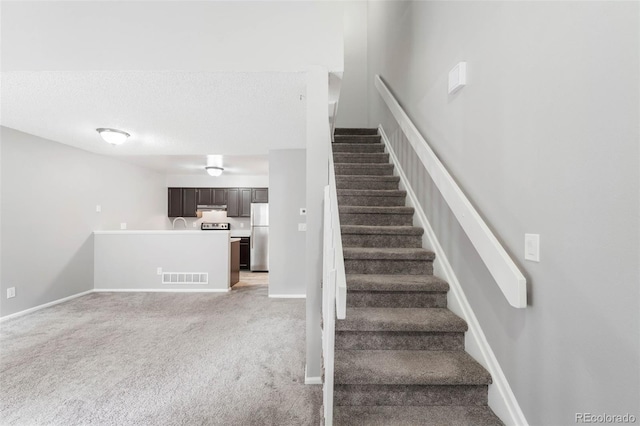 14343 E Dickinson Dr Unit E, Aurora, CO 80014 - staircase featuring carpet floors, baseboards, and visible vents