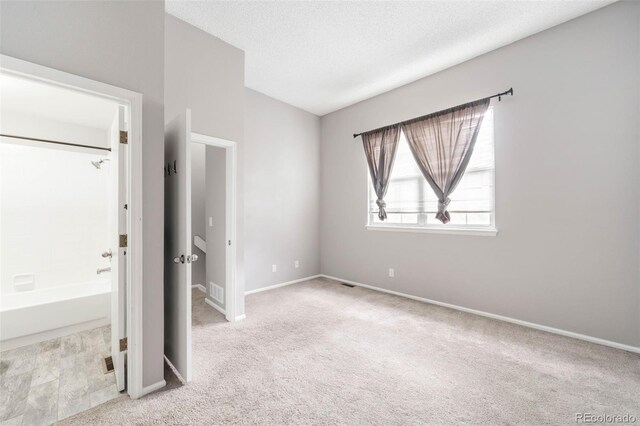 14343 E Dickinson Dr Unit E, Aurora, CO 80014 - unfurnished bedroom with carpet floors, a textured ceiling, baseboards, and visible vents