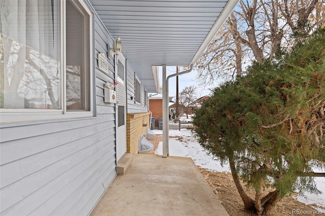 view of snowy exterior featuring a patio