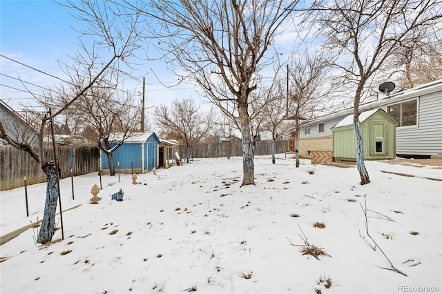 snowy yard with a storage unit