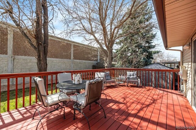 8210 W 72nd Pl, Arvada, CO 80005 - deck with outdoor dining area and an outdoor hangout area