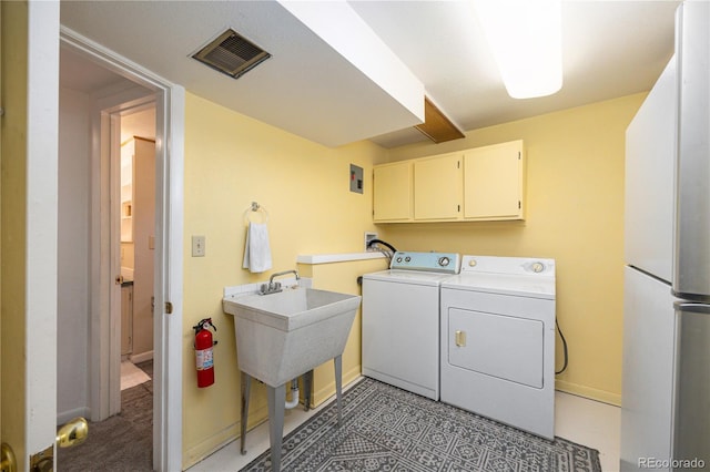 8210 W 72nd Pl, Arvada, CO 80005 - laundry area with washing machine and dryer, cabinet space, and baseboards