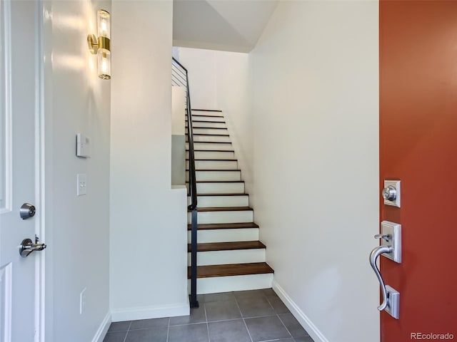 entrance foyer featuring dark tile patterned flooring