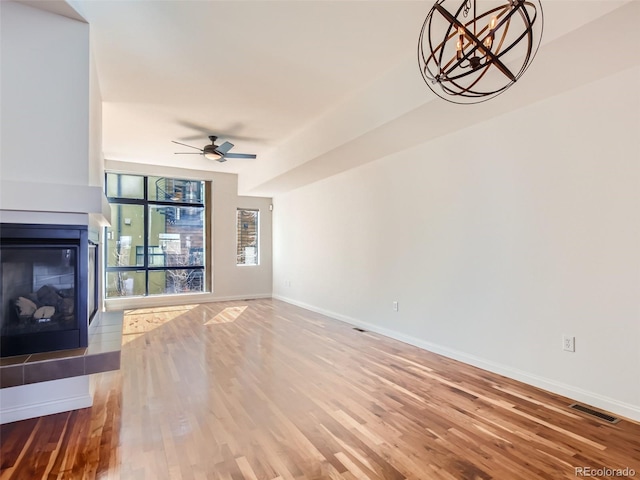 unfurnished living room with ceiling fan and hardwood / wood-style flooring