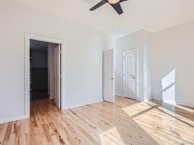 empty room with ceiling fan and light wood-type flooring