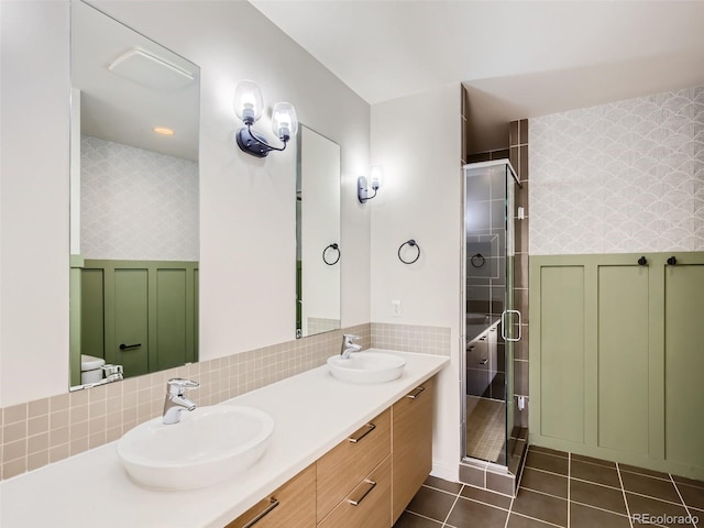 bathroom with toilet, vanity, backsplash, walk in shower, and tile patterned floors