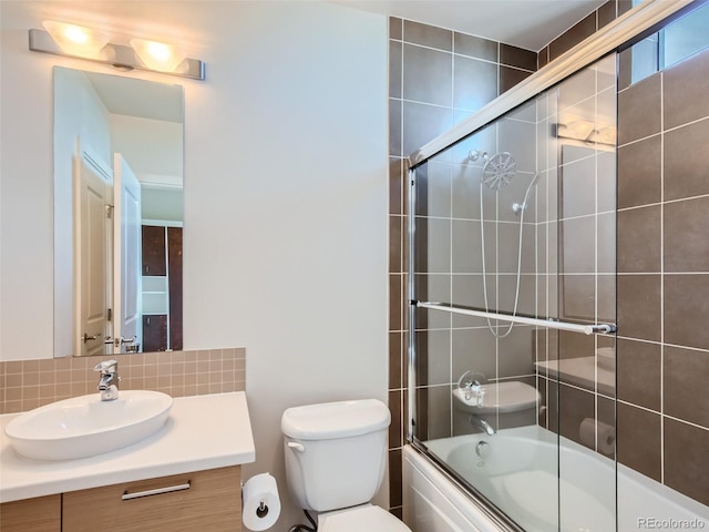 full bathroom featuring toilet, vanity, and shower / bath combination with glass door