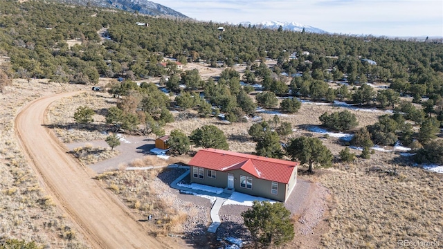2037 Lost Cave Way, Crestone, CO 81131 - view from above of property featuring a mountain backdrop and a heavily wooded area