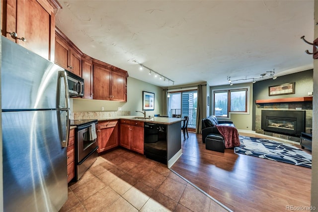 310 Iron Horse Way Unit D5034, Winter Park, CO 80482 - kitchen featuring stainless steel appliances, rail lighting, a peninsula, and a sink
