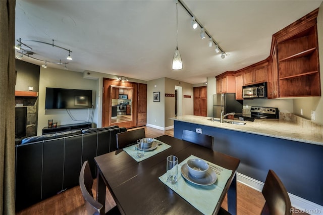 310 Iron Horse Way Unit D5034, Winter Park, CO 80482 - dining space featuring rail lighting, dark wood-style flooring, and baseboards