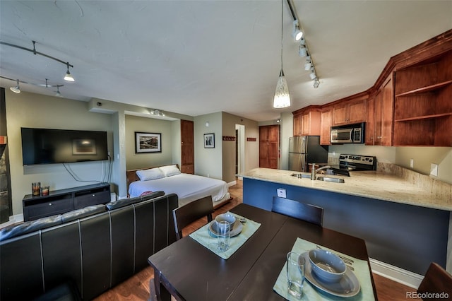 310 Iron Horse Way Unit D5034, Winter Park, CO 80482 - kitchen featuring appliances with stainless steel finishes, rail lighting, open floor plan, a peninsula, and open shelves
