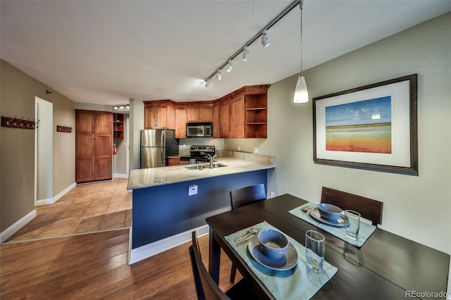 310 Iron Horse Way Unit D5034, Winter Park, CO 80482 - kitchen with stainless steel appliances, open shelves, a peninsula, a sink, and brown cabinets