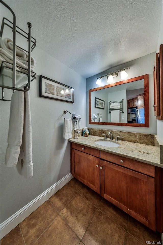 310 Iron Horse Way Unit D5034, Winter Park, CO 80482 - bathroom featuring vanity, tile patterned floors, baseboards, and a textured ceiling