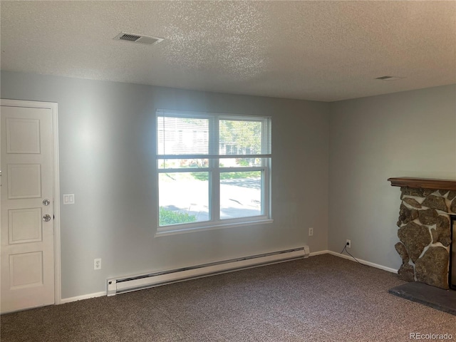 2617 S Cimarron St, Aurora, CO 80014 - unfurnished living room with a baseboard radiator, dark colored carpet, a textured ceiling, healthy amount of natural light, and a stone fireplace