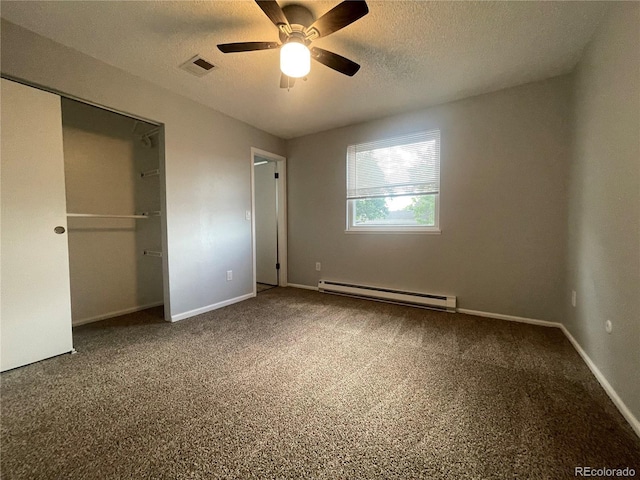 2617 S Cimarron St, Aurora, CO 80014 - unfurnished bedroom with a baseboard heating unit, carpet floors, a textured ceiling, baseboards, and a closet