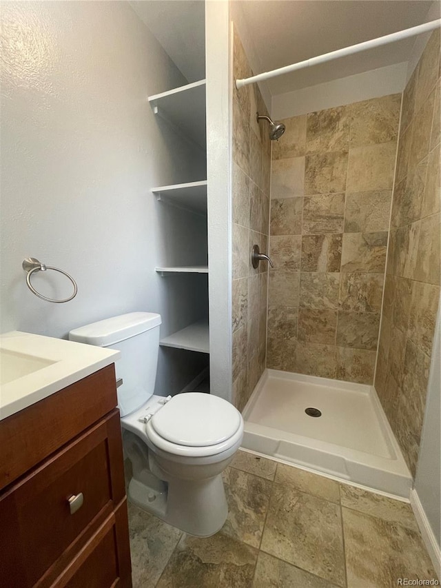 2617 S Cimarron St, Aurora, CO 80014 - bathroom featuring vanity, toilet, and tiled shower