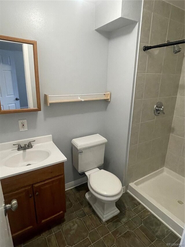 2617 S Cimarron St, Aurora, CO 80014 - full bath with vanity, toilet, a stall shower, and tile patterned flooring