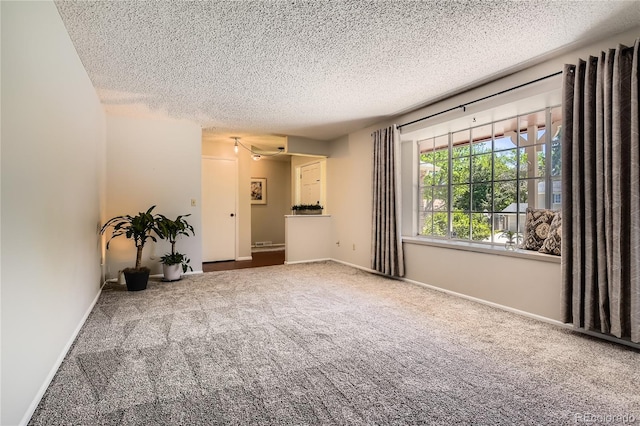 10247 W Arkansas Ave, Lakewood, CO 80232 - empty room featuring a textured ceiling, carpet, and baseboards