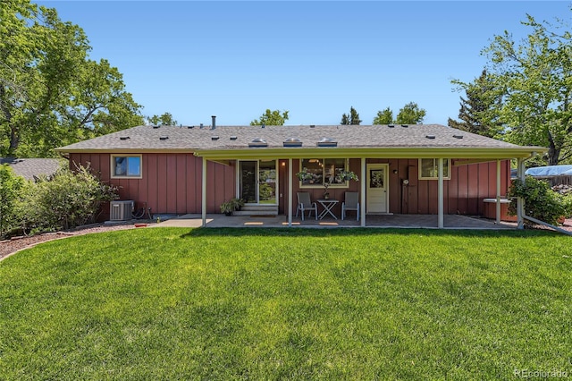 10247 W Arkansas Ave, Lakewood, CO 80232 - back of house with board and batten siding, a yard, and cooling unit