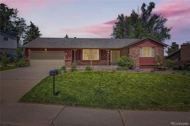 10247 W Arkansas Ave, Lakewood, CO 80232 - ranch-style house with a garage, concrete driveway, a front lawn, brick siding, and board and batten siding