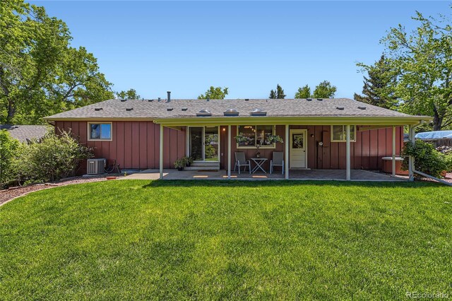 10247 W Arkansas Ave, Lakewood, CO 80232 - back of house with board and batten siding, a yard, and cooling unit
