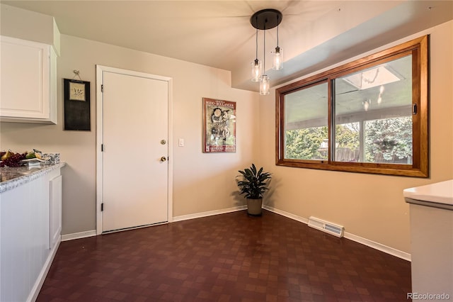 10247 W Arkansas Ave, Lakewood, CO 80232 - unfurnished dining area featuring baseboards