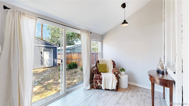 sunroom featuring vaulted ceiling