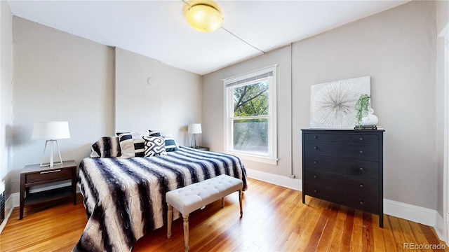 bedroom with light wood-style floors and baseboards