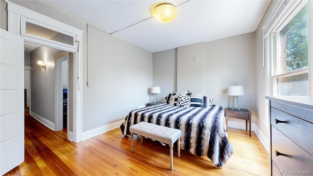 bedroom featuring light wood-type flooring and baseboards