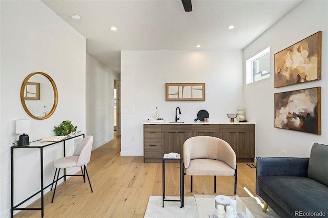 home office featuring sink and light hardwood / wood-style floors