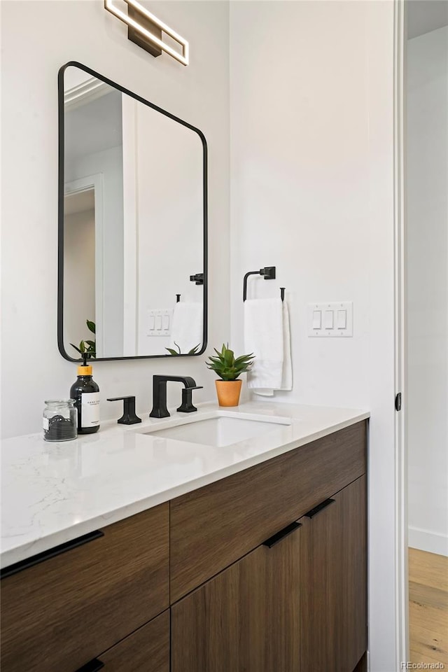 bathroom with wood-type flooring and vanity