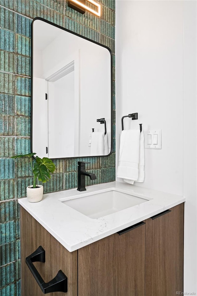 bathroom featuring vanity and decorative backsplash