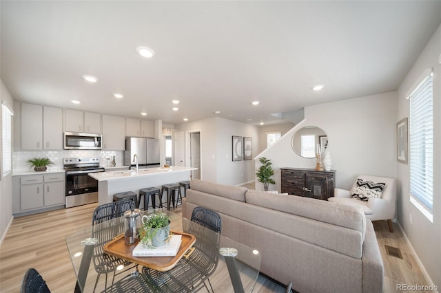13616 E 103rd Pl, Commerce City, CO 80022 - living area featuring recessed lighting, light wood-style floors, and plenty of natural light