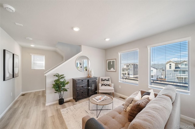 13616 E 103rd Pl, Commerce City, CO 80022 - living area featuring light wood-type flooring, healthy amount of natural light, recessed lighting, and stairway
