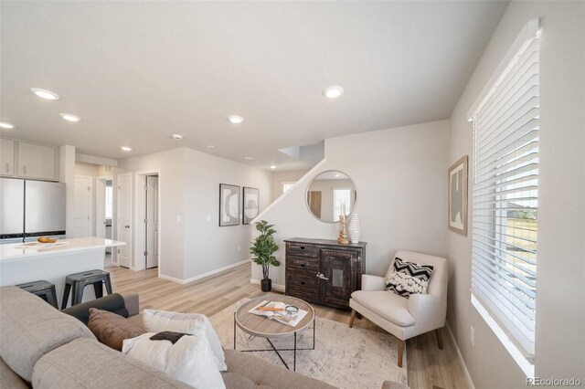 13616 E 103rd Pl, Commerce City, CO 80022 - living room with light wood-type flooring, healthy amount of natural light, and recessed lighting