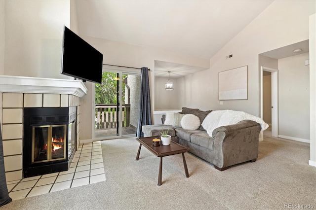 carpeted living area featuring a tile fireplace, high vaulted ceiling, and baseboards