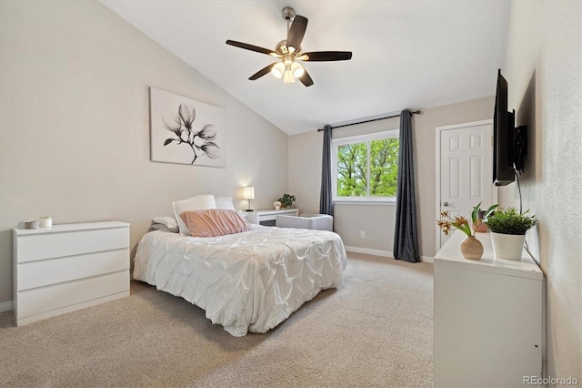 bedroom featuring vaulted ceiling, light colored carpet, baseboards, and a ceiling fan