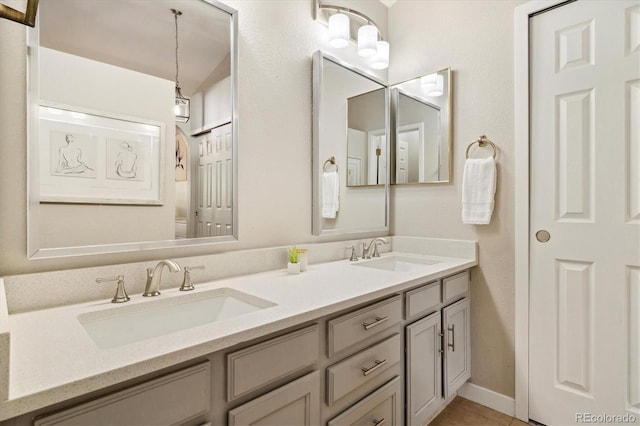 full bath with double vanity and tile patterned flooring