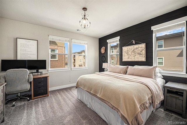 15274 W 64th Ln Unit 206, Arvada, CO 80007 - carpeted bedroom featuring baseboards, multiple windows, a notable chandelier, and visible vents
